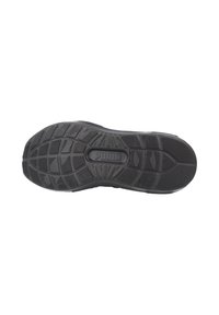 Semelle extérieure en caoutchouc noir avec un motif de crampons texturé, mettant en avant le logo "PUMA" au centre et diverses lignes de traction pour une adhérence optimale.