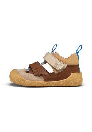 Children's shoe with tan, brown, and blue elements; adjustable straps; rubber sole with textured pattern; suede and fabric materials.