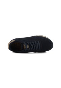 Navy blue sneaker with a textured mesh upper, round toe, and coordinating laces. Features a cork-like accent on the heel.