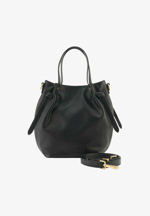 Sac fourre-tout en cuir noir avec doubles poignées, sangles latérales réglables et bandoulière détachable avec quincaillerie dorée, sur fond blanc.