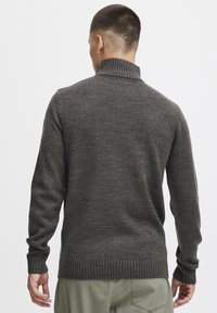 Ciemnoszary sweter dziany z wysokim kołnierzem, z prążkowanymi mankietami i dołem. Gładka tekstura i dopasowany krój. Gładki widok z tyłu.