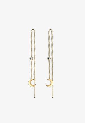 Boucles d'oreilles à fil doré avec pendentifs en croissant de lune et petites pierres précieuses claires sur des chaînes doubles délicates.