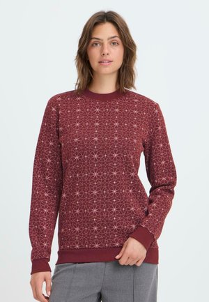 Burgundy sweatshirt with a geometric white pattern, round neck, and ribbed cuffs. Made of soft fabric, featuring a relaxed fit.