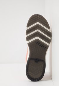 Nike-sneakersula visad mot en vit bakgrund, med ett sicksackmönster i svart och vitt, som framhäver dess greppdesign.