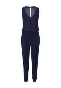 Laivansininen ilmanhiha jumpsuit, jossa on takana avaus, pehmeä kangas, rento istuvuus ja kerätty lahkeiden nahkoissa. Sujuva rakenne koko matkalta.