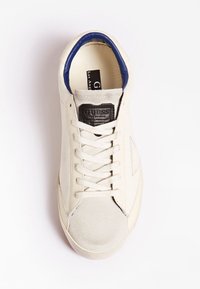 Baskets en cuir blanc avec des accents bleus sur le col et un logo noir sur la languette. Dotées d'un bout texturé et de lacets plats.