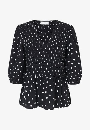 Blusa nera con pois bianchi, con scollatura a V, corpino arricciato e maniche a sbuffo. Forma svasata con dettagli in tessuto testurizzato.