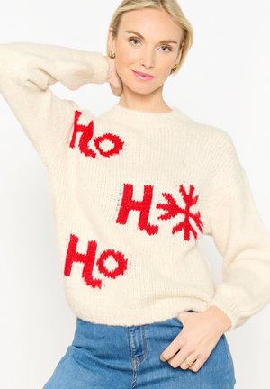 Cremefarbenes Strickpullover mit rotem "Ho"-Text und Schneeflockenmotiv. Rundhalsausschnitt und gerippte Bündchen; weiches, strukturiertes Material.