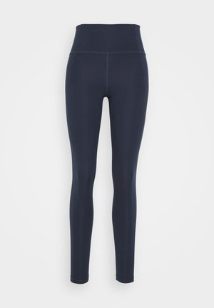 Leggings azul marinho de cintura alta feitos de um tecido elástico e suave. Apresentam um silhueta ajustada com costuras planas e sem padrões visíveis.