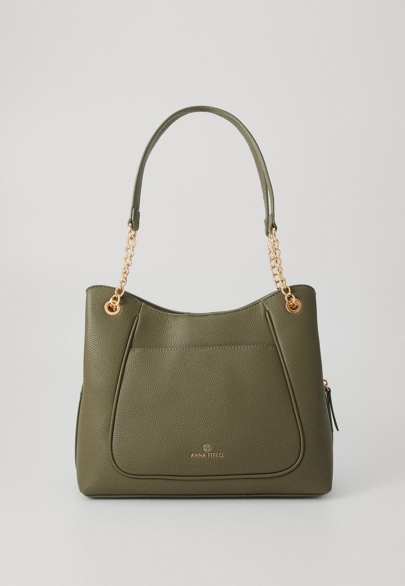 Olive green faux leather handbag with a textured surface and gold-tone chain-accented handles. Features a main compartment and front pocket.