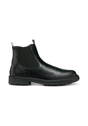 Botín Chelsea de cuero negro con paneles elásticos en los laterales, tiradores y una suela de goma texturizada para tracción. Acabado suave, diseño minimalista.
