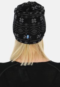 Black knitted beanie with gray floral and geometric patterns, featuring a small blue and yellow flag accent at the back. Soft texture.