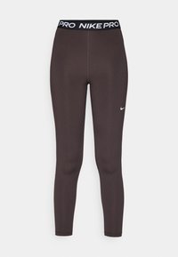 Nike Pro Leggings aus dunkelbraunem Stoff, mit einem schwarzen Bündchen, das den Schriftzug "NIKE PRO" trägt, und einem kleinen weißen Logo am Unterschenkel.