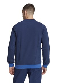 Marineblauwe sweatshirt gemaakt van gestructureerde stof, met een ronde halslijn, geribbelde manchetten en een blauwe accent bij de tailleband.