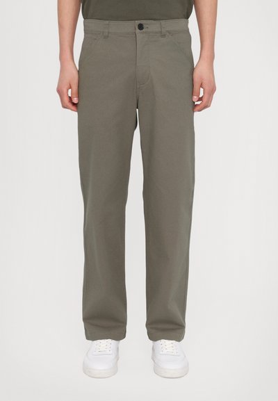 Olive green pants made of cotton blend, featuring a straight leg design, front pockets, and a button closure. Paired with white sneakers.