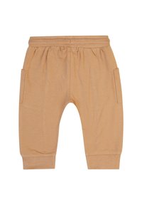 Hellbraune Baumwollhose mit elastischem Bund, schmal zulaufenden Beinen und zwei seitlichen Taschen. Glatte Textur mit gerippten Bündchen an den Knöcheln.