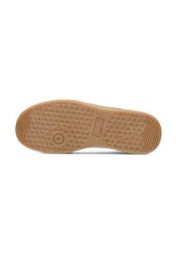 Semelle de chaussure en caoutchouc brun avec une texture en nid d'abeille, présentant un motif circulaire et de légères rainures près des bords pour améliorer l'adhérence.