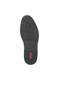 Suela de zapato negra con un patrón de agarre texturizado. Presenta una sección central lisa y un logo en rojo. Diseñada para durabilidad y tracción.