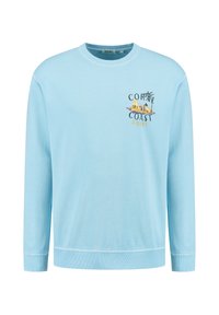 Felpa a maniche lunghe di colore azzurro chiaro in materiale cotone. Presenta una stampa grafica con il testo "Coral Coast" e palme e capanne illustrate.