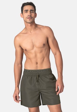 Olive green swim shorts made of lightweight fabric, featuring an elastic waistband with adjustable drawstring and logo accent on the waistband.