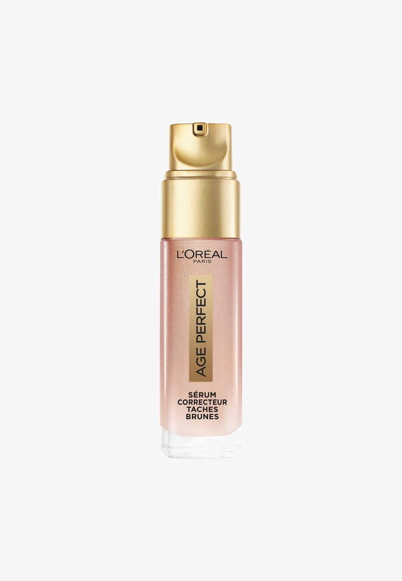 Sérum L'Oréal Age Perfect dans un flacon en verre transparent avec un bouchon pompe doré. Le flacon présente un dégradé de teinte rose et un texte noir.