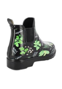 Zwarte rubberen Chelsea-boots met groene kruidenpatronen en tekst. Elastische zijpanelen en een trekband voor gemakkelijk aantrekken. Dikke zwarte zool.