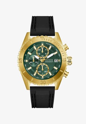 Montre chronographe en or avec un cadran vert, un bracelet en caoutchouc noir, des sous-cadrans, une lunette tachymétrique et des index d'heure blancs. Affichage de la date à 3 heures.