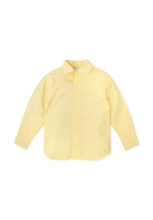 Camisa amarilla con botones y rayas verticales blancas, mangas largas y cuello estándar. Cuenta con un pequeño logo en el dobladillo inferior.