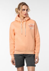 Perzikkleurige hoodie van zachte stof, met een voorzak, trekkoorden en een bedrukte opdruk met de tekst "Spread your Love" in het wit.