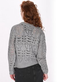 Maglione grigio a maglia con un motivo a foglia traforato, maniche lunghe e polsini a costine, con un fit leggermente corto in vita.