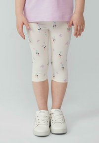 Leggings aus weichem, elastischem Stoff in Creme, mit bunten Mustern von Personen, Palmen und Wolken. Verkürzte Länge mit einem taillierten Design.