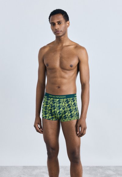 Green and yellow patterned boxer shorts made of soft fabric with a fitted design and a branded waistband featuring "Emporio Armani."