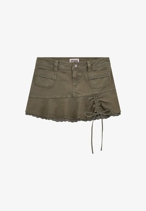 Olive green cotton skirt features a flared design, scalloped hem, two front pockets, and a drawstring detail on one side.