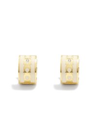Gold-tone hoop earrings with cut-out designs, featuring circular patterns and a small clear gemstone accent. Smooth and polished texture.
