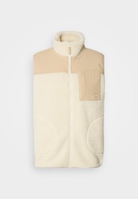 Beige fleece vest with high collar, a zippered front, and a pocket. Soft texture with oversized side pockets.