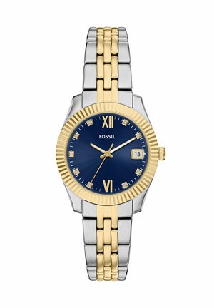 Fossil ur med en blå urskive, sølv- og guldfarvet rustfrit stålrem, prydet med diamantdetaljer og en datovisning kl. 3.