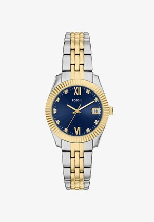 Montre Fossil avec un cadran bleu, bracelet en acier inoxydable doré et argenté, rehaussée de diamants, et affichage de la date à 3 heures.