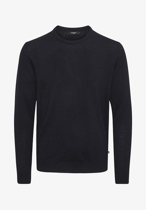 Juodas ilgas megztinis iš smulkios mezginio medžiagos, su apvaliu iškirpimu ir įstrižais manžetais, su maža etikete šone.