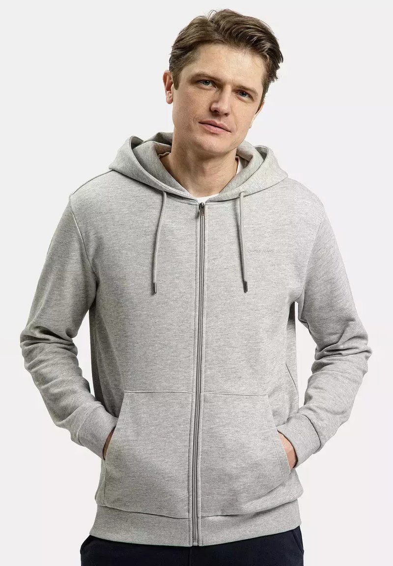 Jasnoszara bluza z kapturem na zamek, wykonana z miękkiej mieszanki bawełny, z przednią kieszenią, sznurkami do regulacji oraz ściągaczami przy mankietach i u dołu.