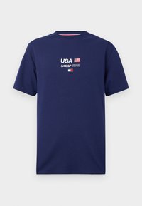 Navy blue cotton T-shirt featuring "USA" and "SAIL GP TEAM" embroidered in white and red, with a flag graphic above the text.