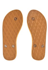 Tan rubber shoe soles with a textured pattern and three circular glitter accents, featuring a smooth edge and defined contours.