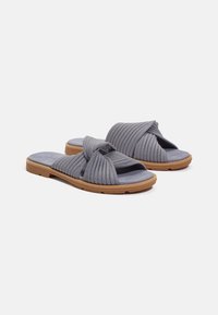Gray fabric slide sandals with a twisted strap design, soft suede-like footbed, and a rubber outsole. Features textured detailing on straps.