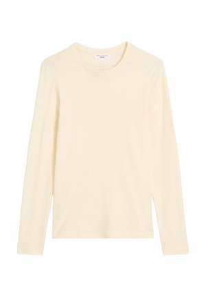 Koszulka z długim rękawem, z okrągłym dekoltem w jasnym kremowym kolorze. Wykonana z miękkiego, gładkiego materiału o klasycznym kroju, bez widocznych logo ani wzorów.