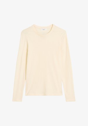 Ilgi piedurkņu krekls ar apaļu kakla izgriezumu gaiši krēmkrāsā. Izgatavots no mīksta, gluda auduma ar klasisku piegriezumu un bez redzamām emblēmām vai rakstiem.