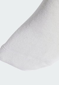 Biała bawełniana skarpetka o gładkiej teksturze, żebrowanej tkaninie i zaokrąglonym palcu. Prosty design bez wzorów i widocznych akcentów.