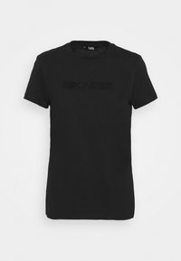 Černé bavlněné tričko s krátkým rukávem, se strukturovaným logem uprostřed. Kulatý výstřih se standardním střihem.