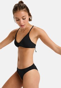 Black bikini set featuring a triangular top with adjustable straps and a classic bottom. Made of smooth, stretchy fabric.