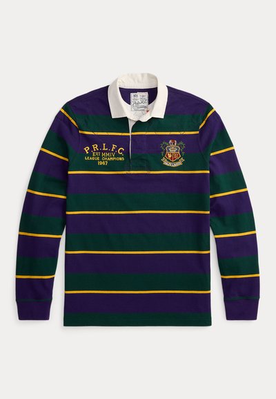 Μπλούζα ράγκμπι με ρίγες σε μωβ, πράσινο και κίτρινο. Διαθέτει λευκό γιακά και κεντημένο λογότυπο με κείμενο στο μπροστινό μέρος. Από βαμβακερό υλικό.