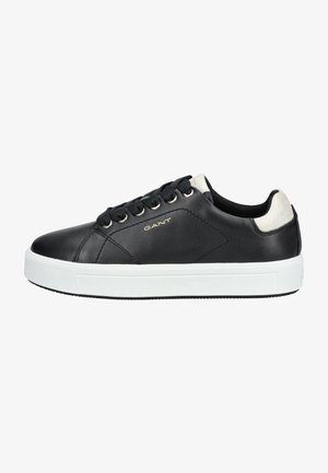 Black leather sneaker with white rubber sole. Features round laces, metal eyelets, and beige accents at the heel. Brand logo present.
