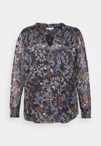 Blusa trasparente e scura con un motivo floreale in rosso, giallo e blu. Maniche lunghe con polsini arricciati e scollatura a V.